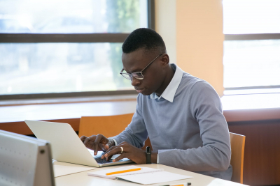 young researcher working on a laptop